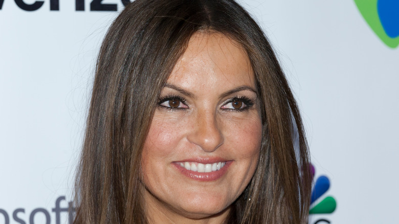 Mariska Hargitay smiling in front of grey background