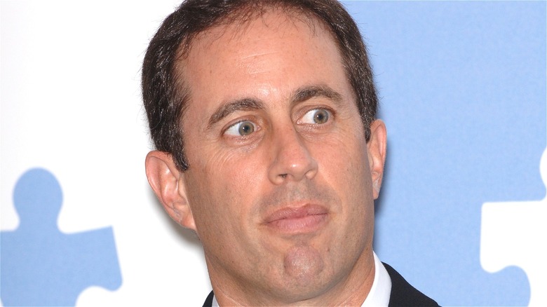 Jerry Seinfeld stares at something unknown and presumably horrifying beyond the frame of this picture