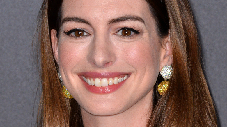 Anne Hathaway smiles