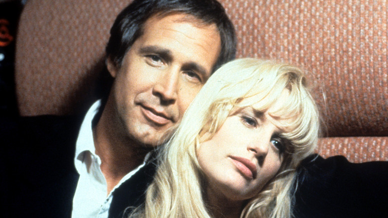 Chevy Chase poses with Daryl Hannah on the set of 