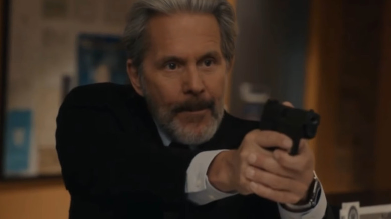 Alden Parker holding a gun 