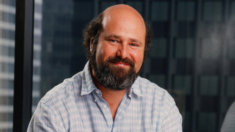 Rob Reiner smiles near an office window
