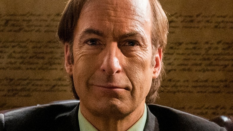 Saul stares smugly from behind his desk