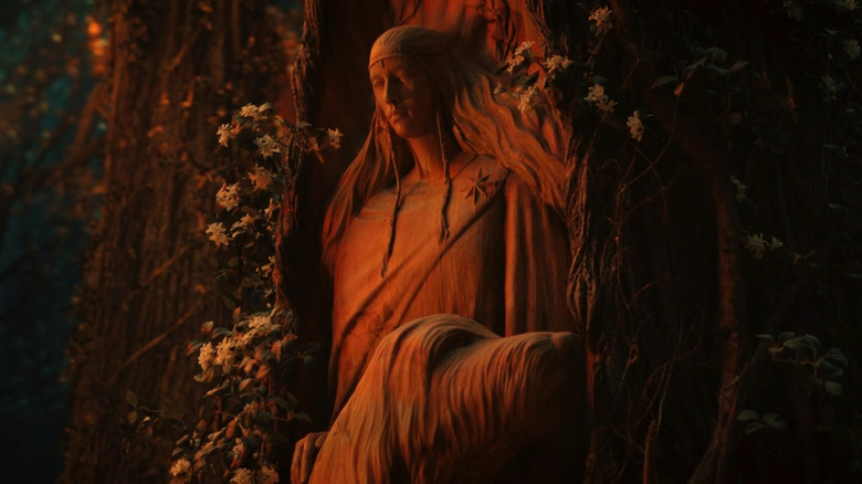 A statue of Lúthien carved into a tree