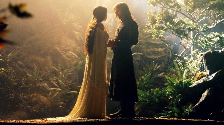 Arwen and Aragorn meet on a bridge in a garden