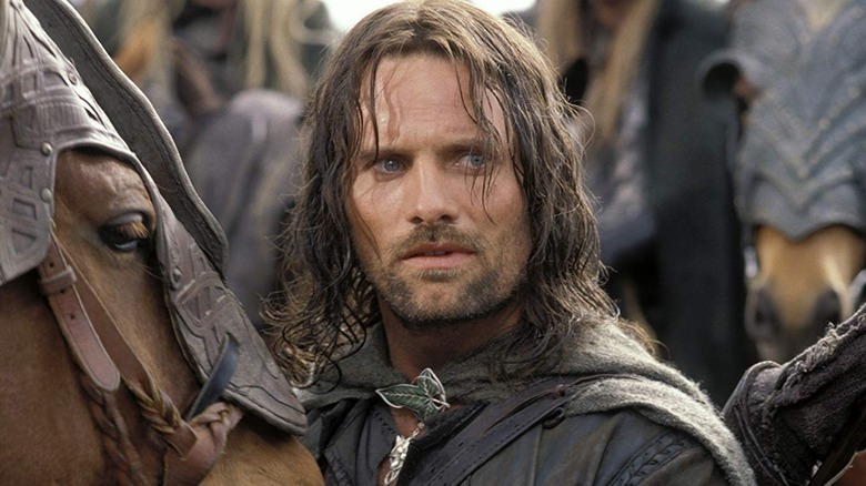 Aragorn standing by a horse