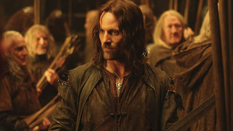 Aragorn surrounded by old men in Helm's Deep