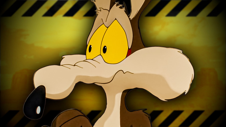 The Coyote looking scared with a warning sign background