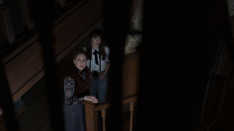 Lorraine and Judy Warren looking upstairs nervously