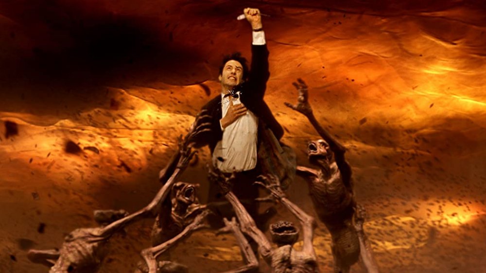 Keanu Reeves as Constantine in a hoard of demons