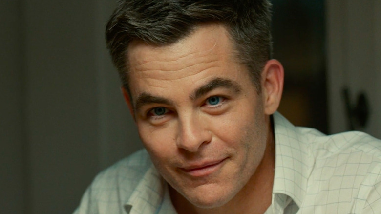 Chris Pine smiling as James Harper in The Contractor