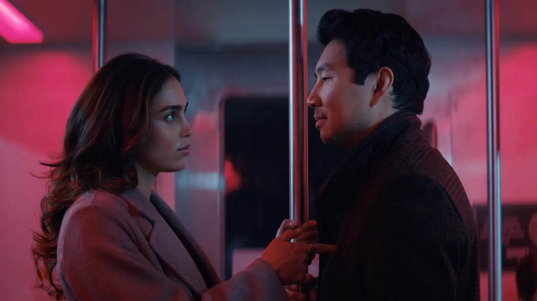 Michelle talks to Alexander on a train in "The Copenhagen Test" (2025)