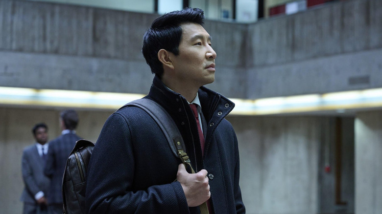 Alexander stands inside a building in 