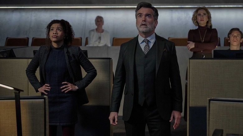 Parker and Moira stare up in surprise in "The Copenhagen Test" (2025)