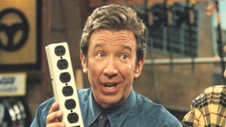 Tim Taylor holding a power strip