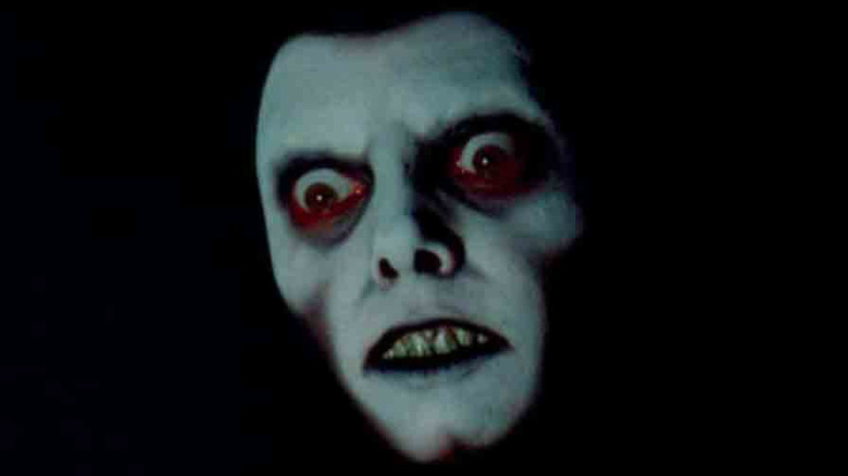 Pazuzu grimaces in darkness