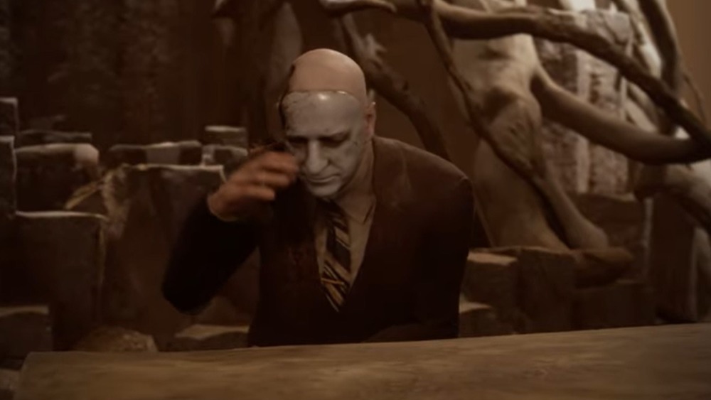 man in mask looking down