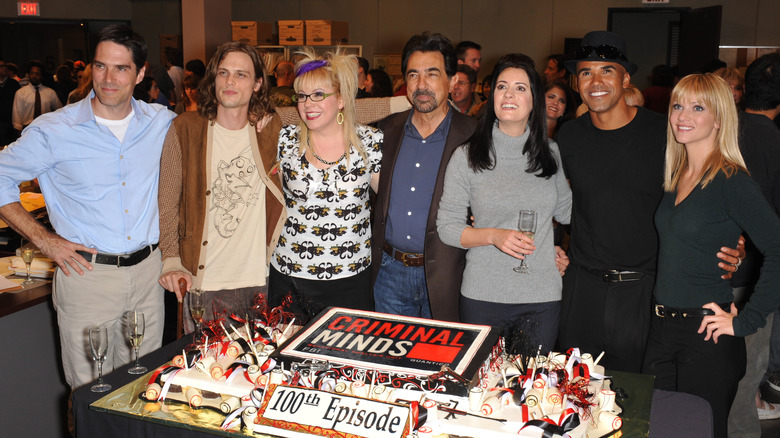 Shemar Moore standing in front of a cake with the Criminal Minds Cast