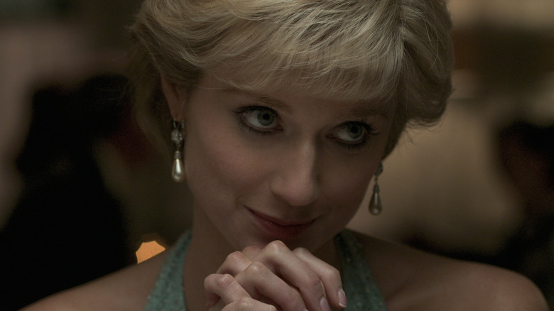 Elizabeth Debicki as Diana clasping hands