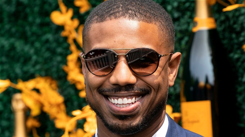 Michael B. jordan with sunglasses on smiling 