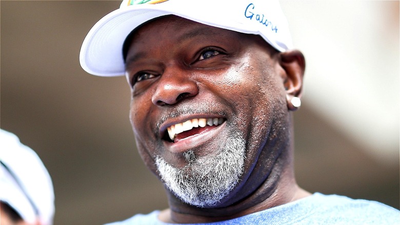 Emmitt Smith smiling, wearing a Gators hat