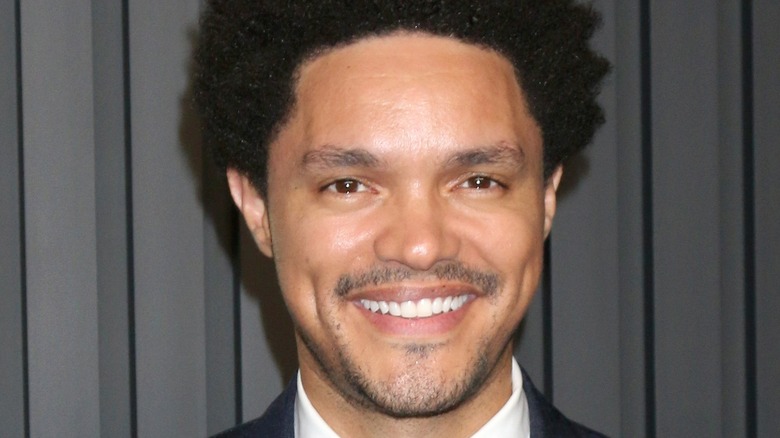 Trevor Noah smiling at a premiere