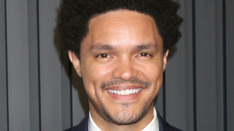 Trevor Noah smiling at a premiere