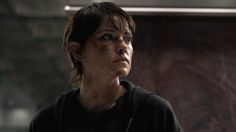 Joey covered in dirt, turns her head in Cleaner (2025)