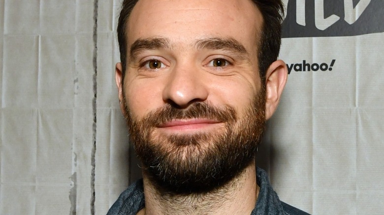 Charlie Cox smiling at event