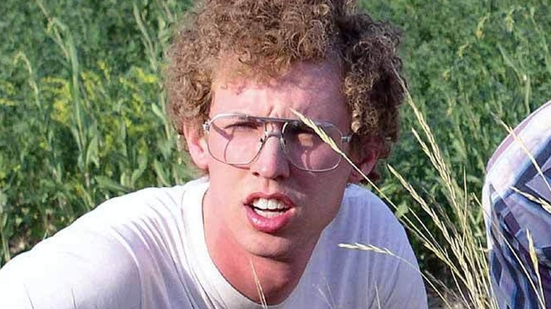 Napoleon Dynamite crouching in the grass