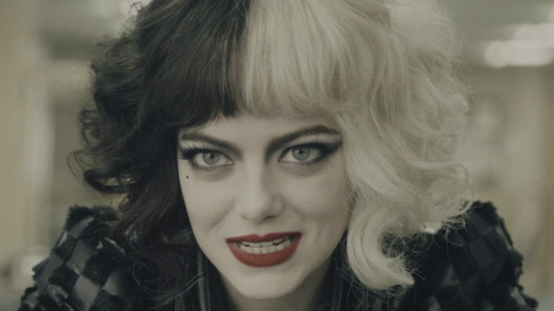 Emma Stone's Cruella grinning mischievously 