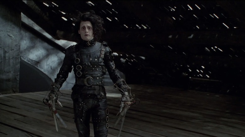 Edward standing in his dark mansion