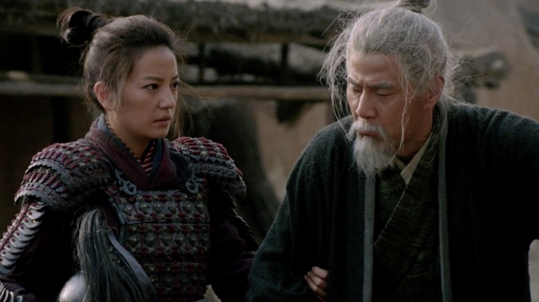 Mulan standing with her father