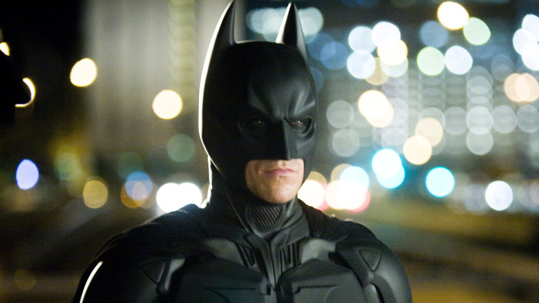 Batman staring against city lights