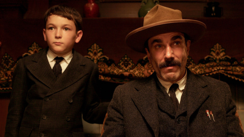 Daniel Plainview sitting with son
