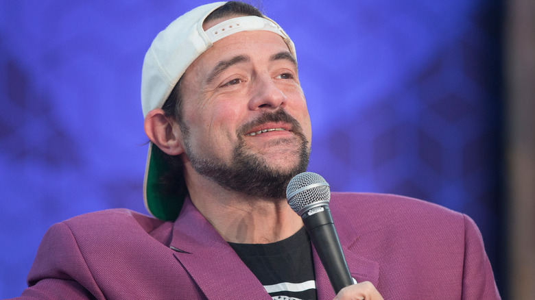 Kevin Smith holding a microphone