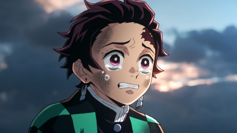 Tanjiro with tears in his eyes