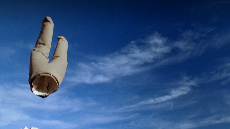 A pair of khaki pants falls from the sky