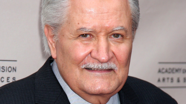 John Aniston with a faint smile at a premier 