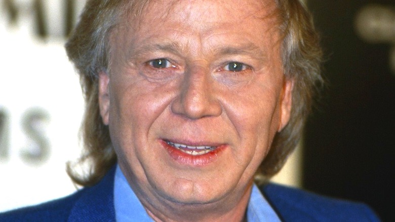 Wolfgang Petersen smiling at press