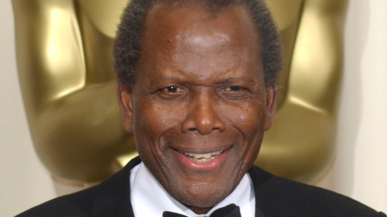 Sidney Poitier posing with his Oscar