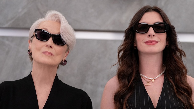 Miranda and Andy wearing sunglasses in the elevator in The Devil Wears Prada 2