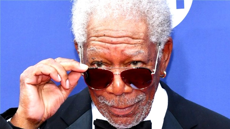 Morgan Freeman tilting sunglasses