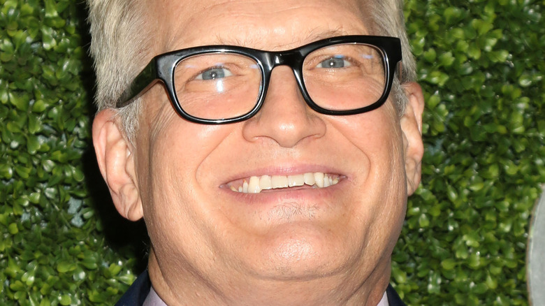 Drew Carey smiling with black glasses