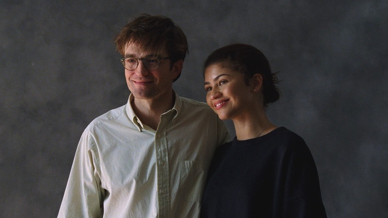 Charlie and Emma smile for a wedding photo in 