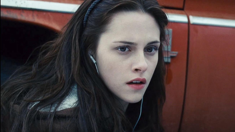 Bella crouching by truck