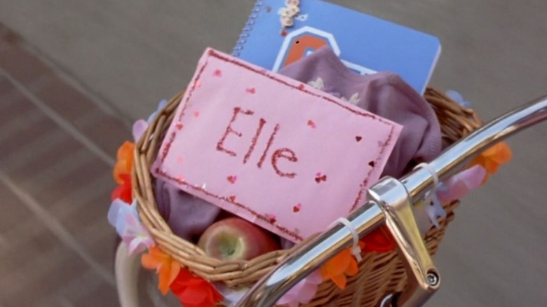 A pink envelope with Elle's name on it sits in a bicycle basket in "Legally Blonde" (2001)