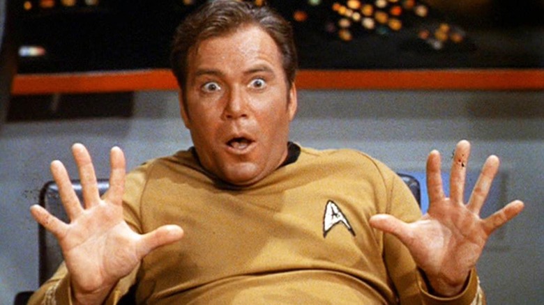 Captain Kirk surprised in his captain's chair in "Star Trek"