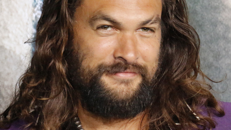 Jason Momoa at event smiling 