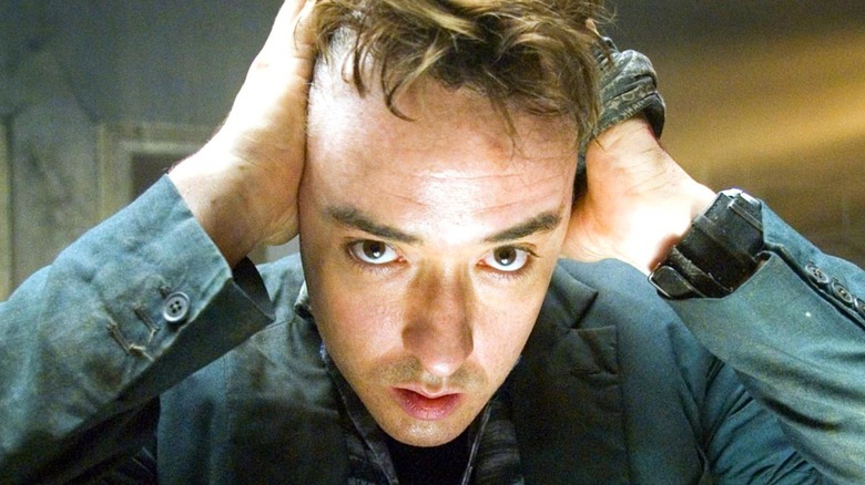 John Cusack as Mile pulling hair